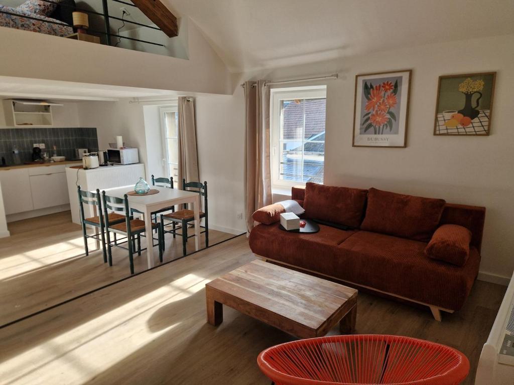 a living room with a couch and a table at Le Logis de Meung Sur Loire in Meung-sur-Loire