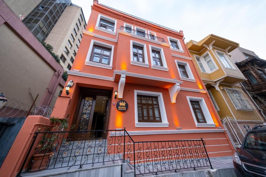 a orange building with a black fence in front of it at The King Suit Beşiktaş in Istanbul