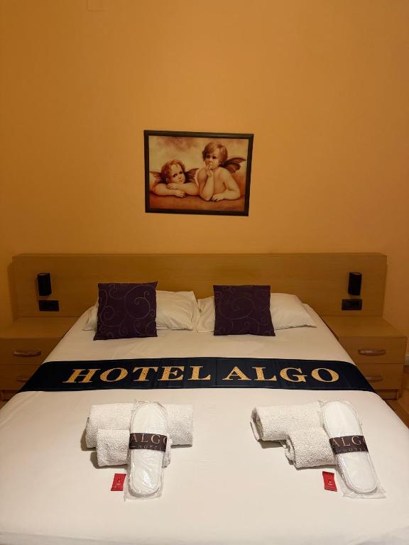 a bedroom with a bed with towels on it at Algo Hotel Tirana in Tirana
