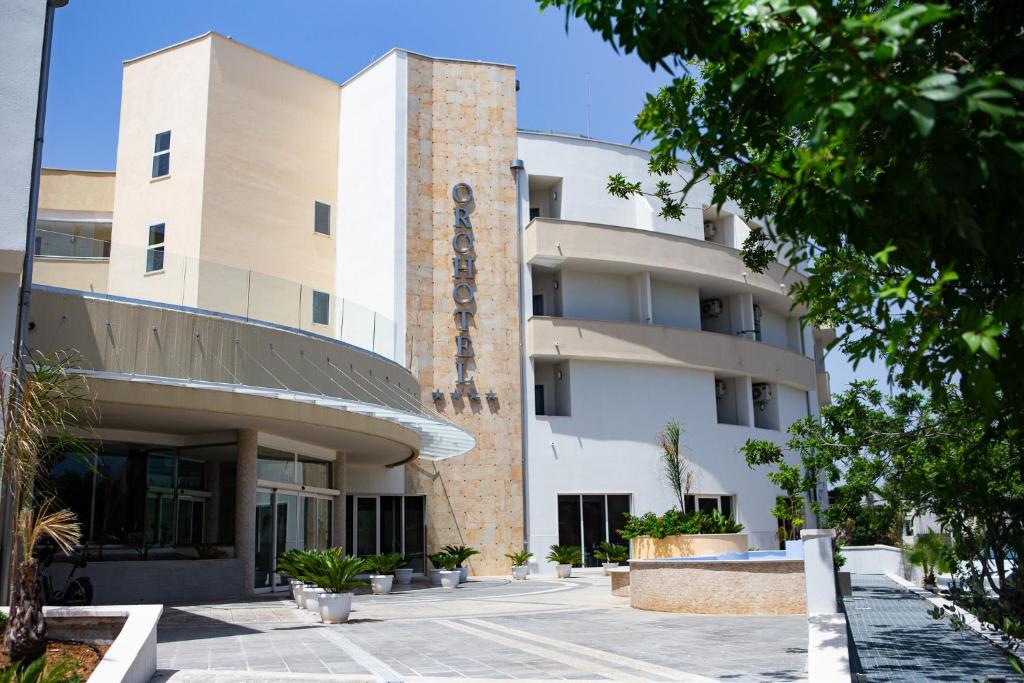 a building with a sign on the side of it at Oro Hotel in Policoro