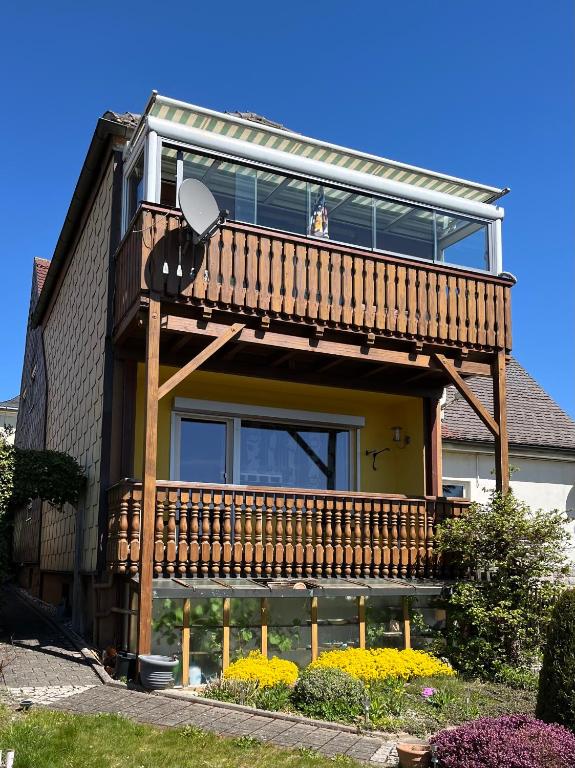 a house with a deck on the side of it at Haus Schneebergblick in Röslau