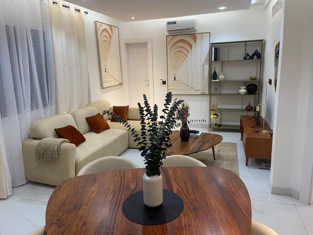 a living room with a table and a couch at Elegance appart-Yoff virage in Dakar