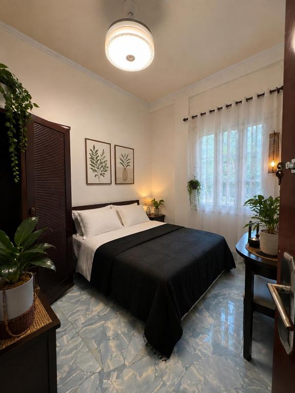 a bedroom with a large bed and a large window at Cazabela in Casisang