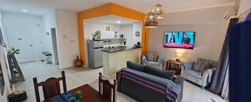 a living room with a couch and a kitchen at Nuestra Recova en Pilar BsAs in Pilar
