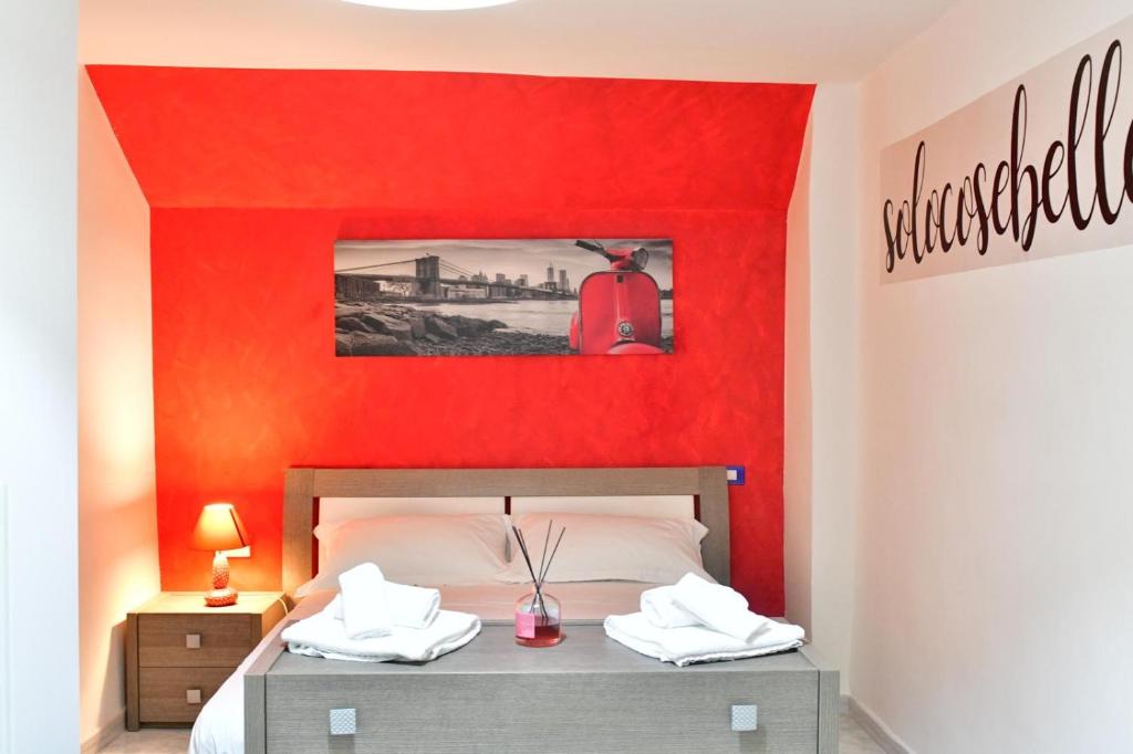 a red bedroom with a bed with a red wall at Gran Paradiso Guest House in Tivoli