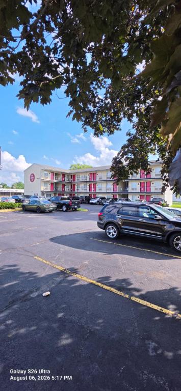 a car parked in a parking lot in front of a building at Red Carpet Inn Williamstown in Williamstown