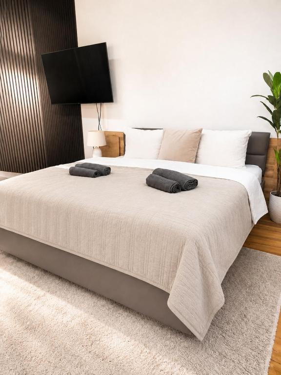 a bedroom with a large bed with two pillows on it at Altstadt-Loft Würzburg in Würzburg