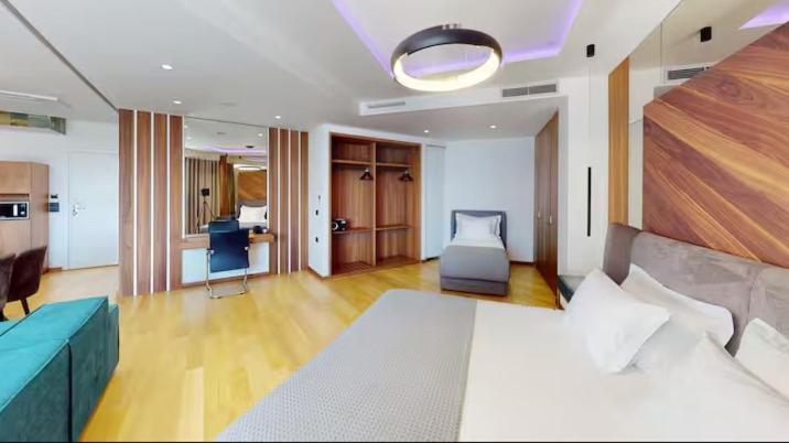 a bedroom with a bed and a living room at Bliss Properties Jacuzzi Suite Free Pool Access in Draç