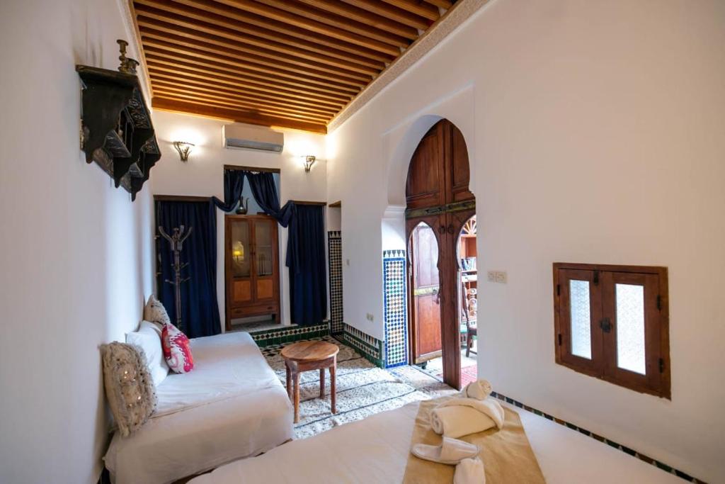 a living room with a couch and a table at Dar Ras Jnan -luxury stay - rooftop in Oulad Akkou