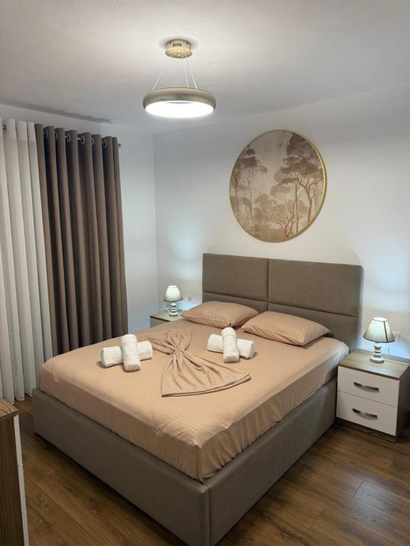 a bedroom with a large bed with two pillows at Topuzi Grand House in Pogradec
