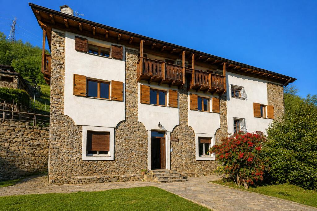 a large brick building with a balcony on it at Ca' Bastiàn in Sacco