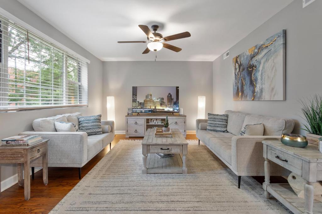 a living room with a couch and a ceiling fan at Chicago Charm in Chicago