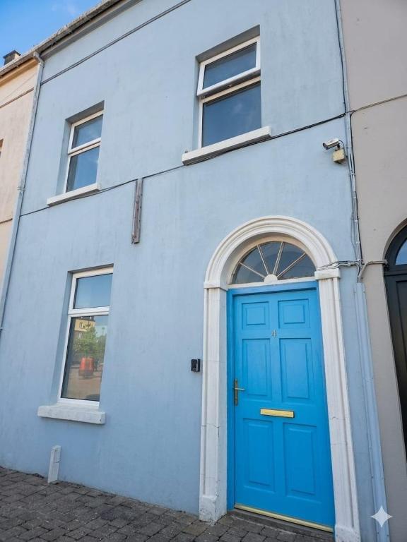 a blue building with a blue door at High Tide House in Waterford