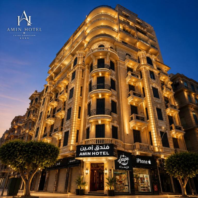 a large building with a sign in front of it at Amin Hotel Cairo Downtown in Cairo