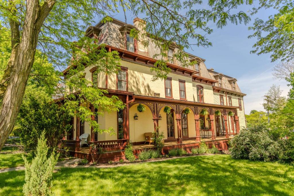 an old house with a green yard at Gould Swaby Mansion in Seneca Falls
