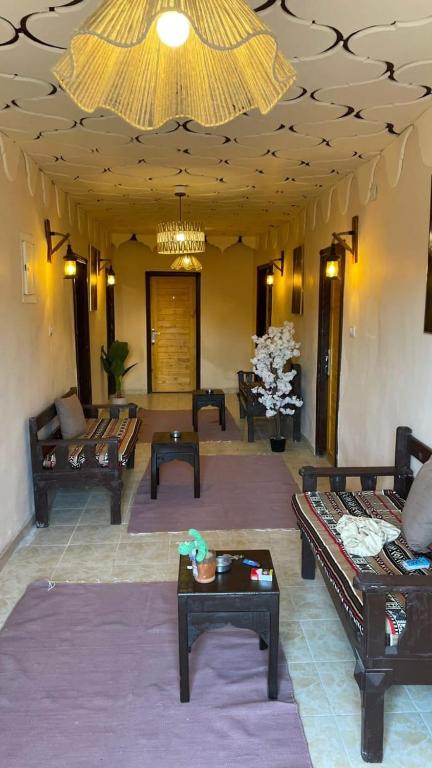 a living room with couches and tables and a ceiling at Lighthouse Inn Dahab in Dahab