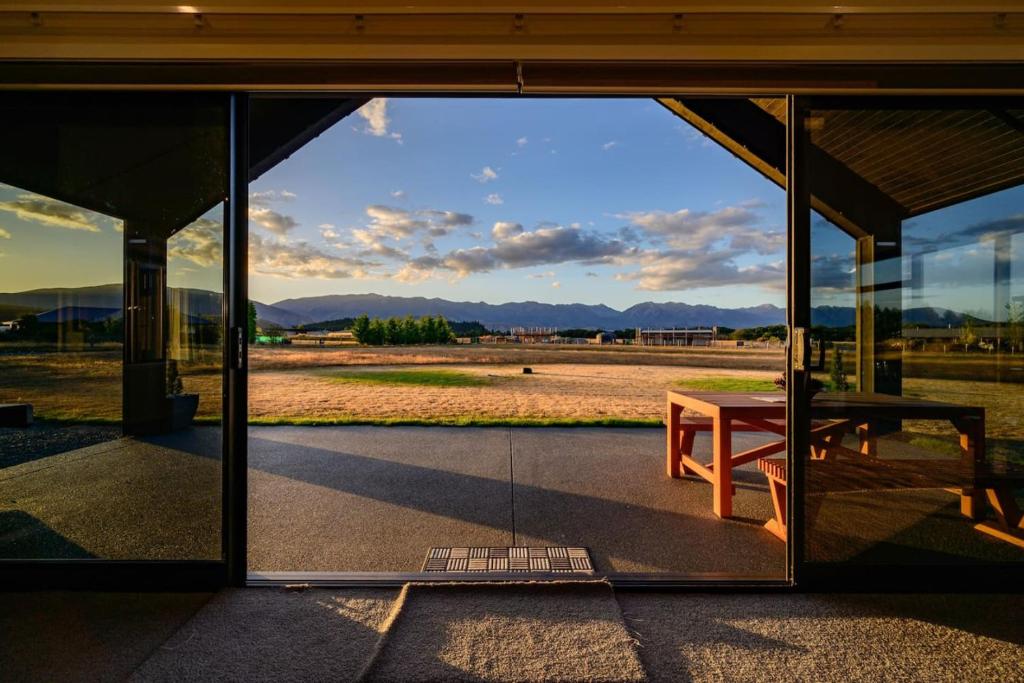 a glass window of a building with a picnic table at 31 on Boundary in Twizel