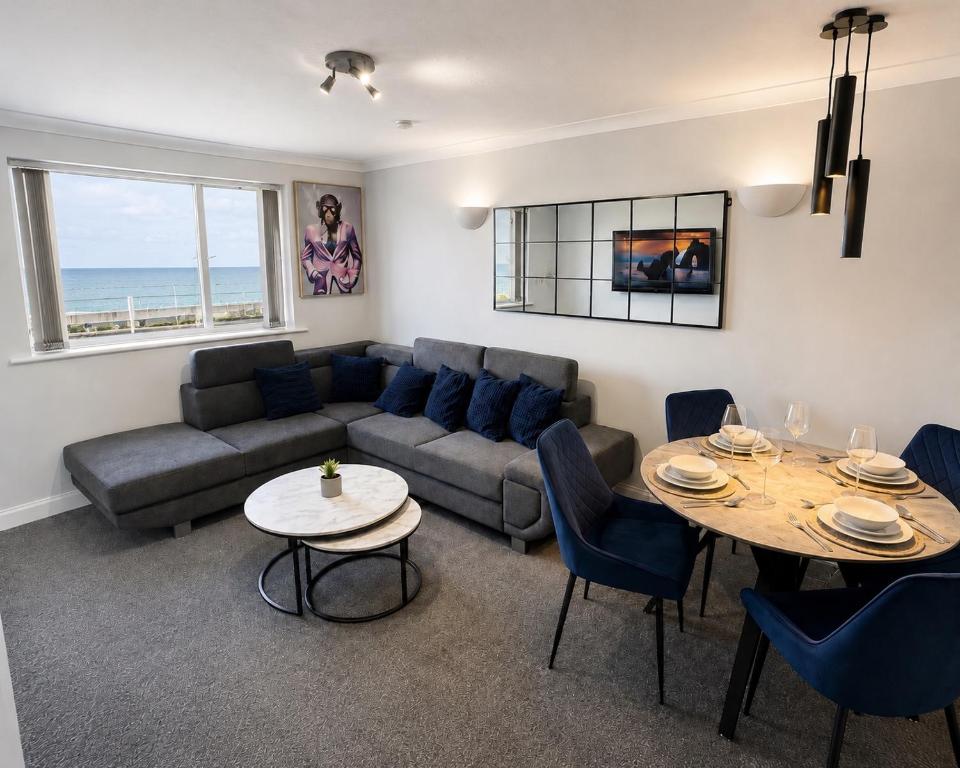 a living room with a couch and a table at Sea-View Luxury Apartment sleeps 5 - Pet Friendly - Fast WiFi - Off Street Parking - Contractors Dream!!! in Sheerness