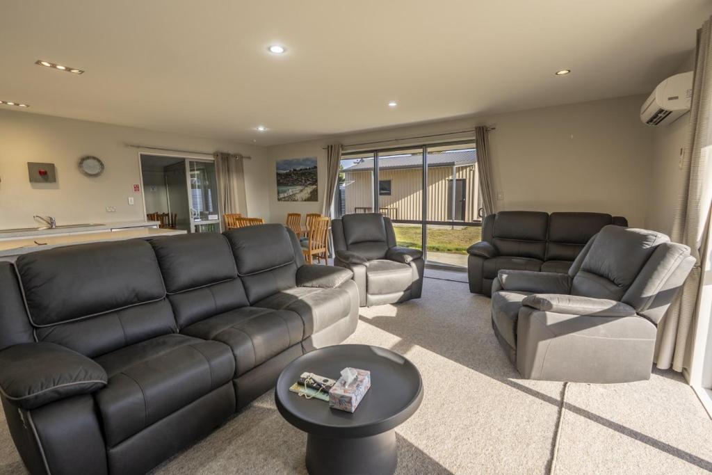 a living room with a couch and chairs and a table at Irishman Drive Escape in Twizel
