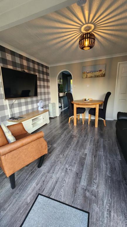 a living room with a couch and a table at Ranger - Snowdon Cabins holiday let Caernarfon in Caeathro