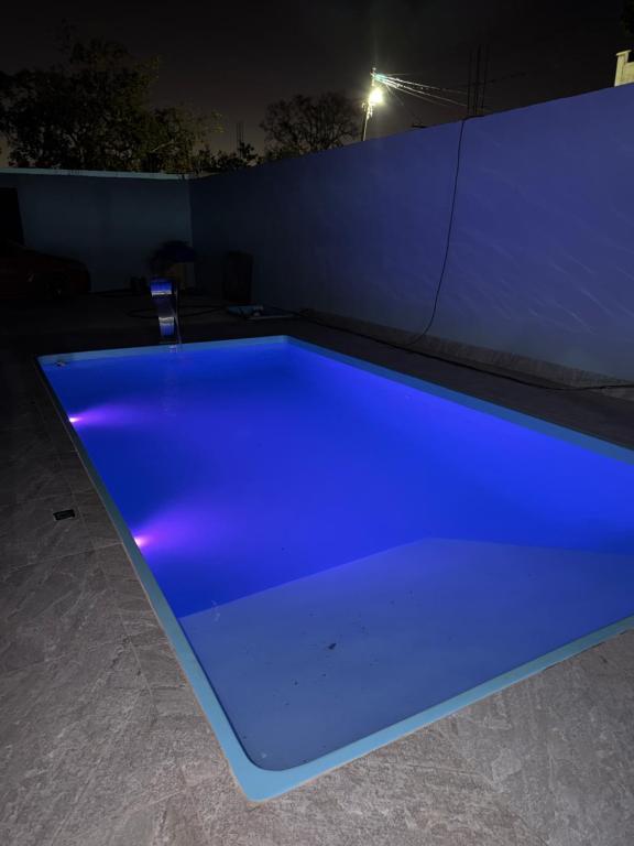 a blue pool in a room at night at Recanto da vale Rs in Três Marias