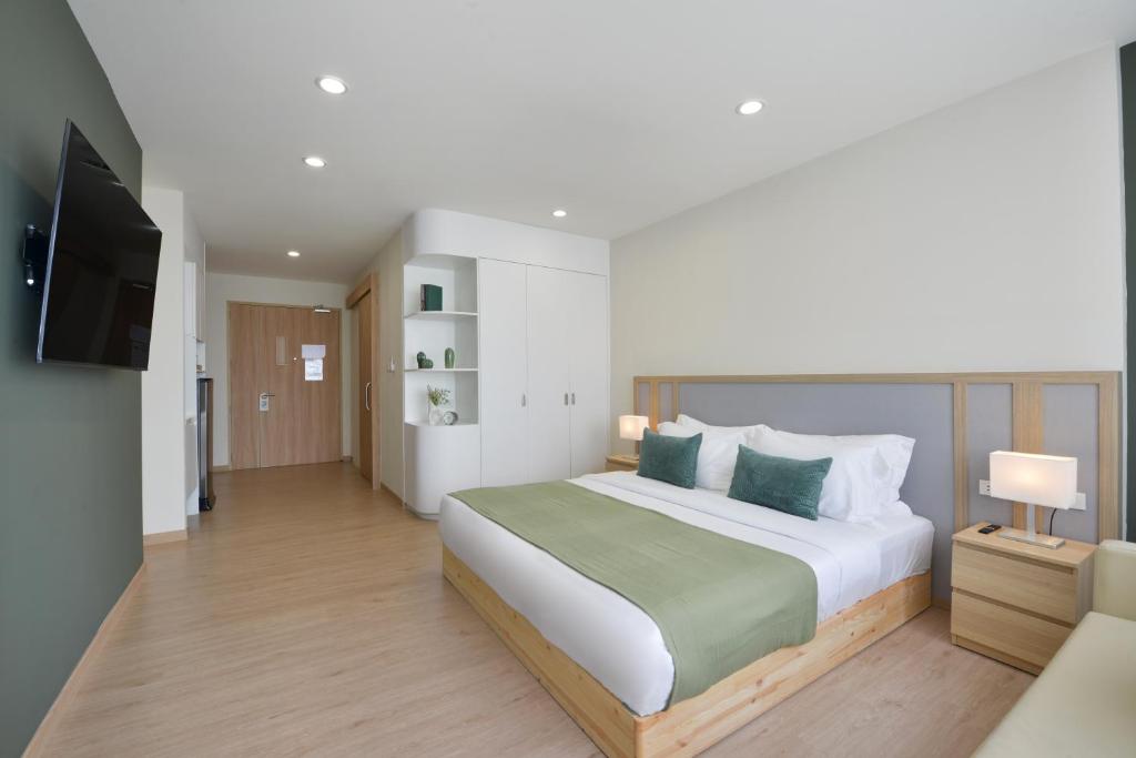 a bedroom with a large bed and a television at SENS Hotel Nonthaburi Bangbuathong in Nonthaburi
