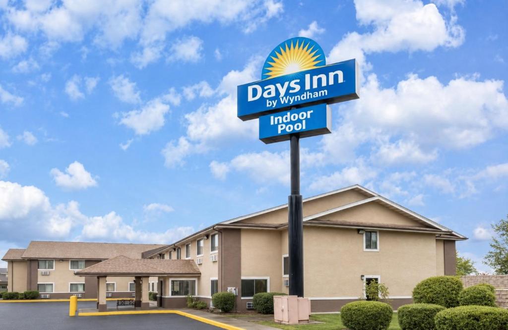 a days inn sign in front of a building at Days Inn by Wyndham Topeka in Topeka
