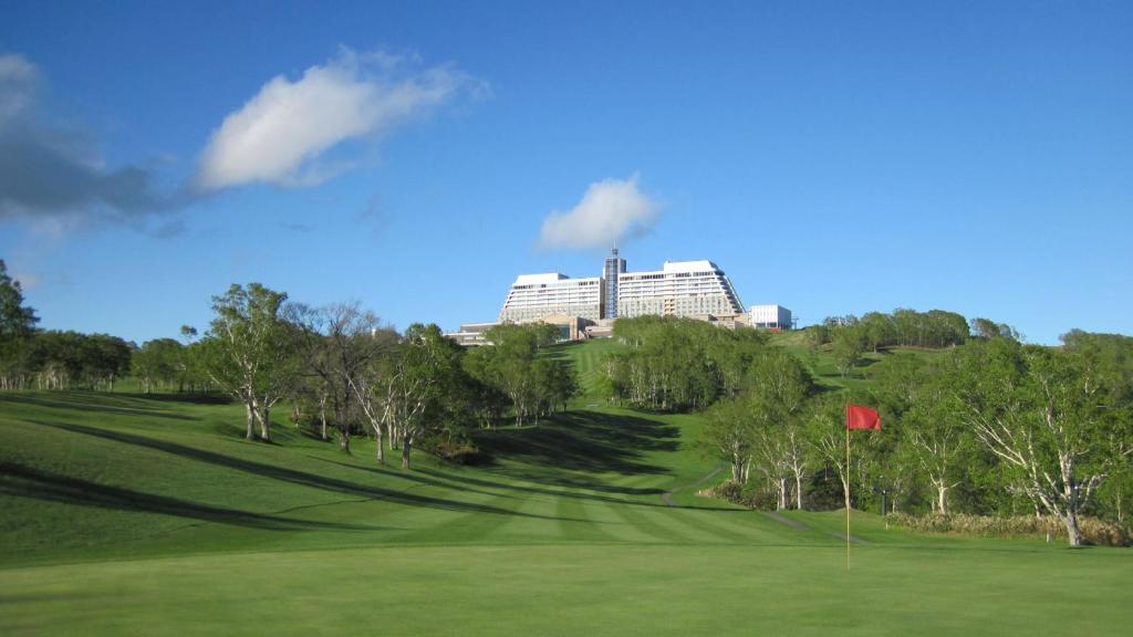 a golf green with a building in the background at The Windsor Hotel TOYA Vignette Collection in Lake Toya