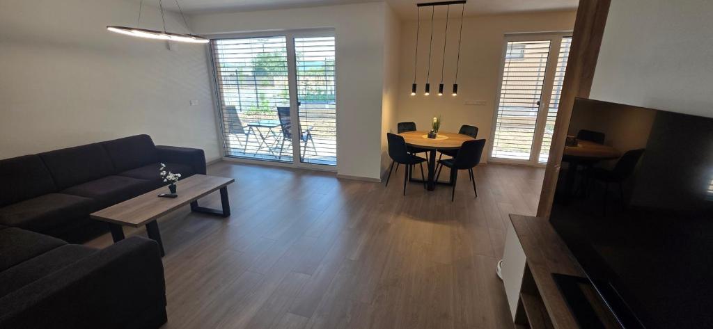 a living room with a couch and a table at Apartmán Hrdličky Trenčín in Trenčín