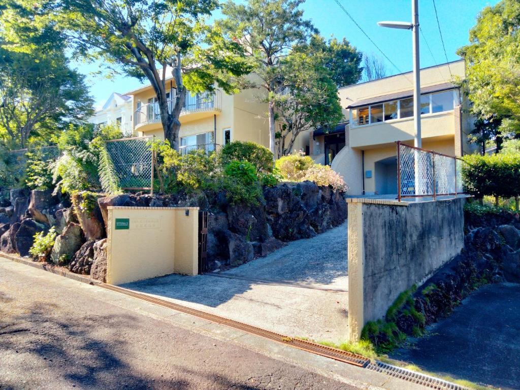 a house on the side of a street at ウテナ2 in Ito