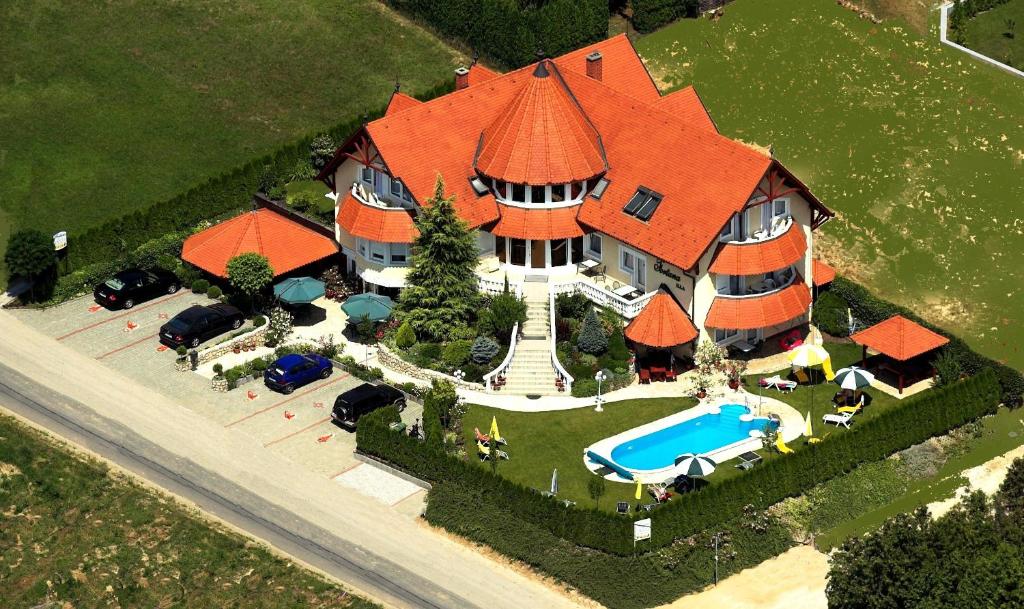 an aerial view of a large house with a swimming pool at Fortuna Villa in Hévíz