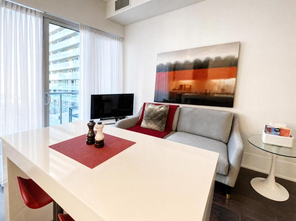 a living room with a white table and a couch at Union Centre Hotel & Suites in Toronto