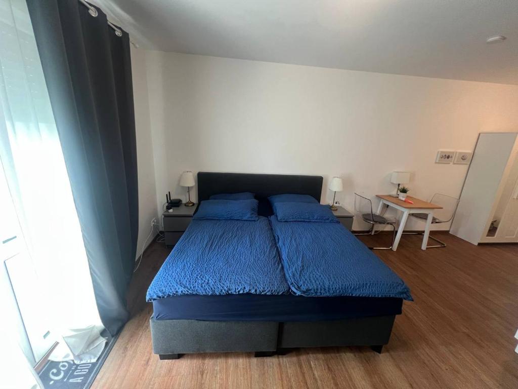 a bedroom with a bed with blue pillows on it at Imperial Baths Boutique Studio in Trier