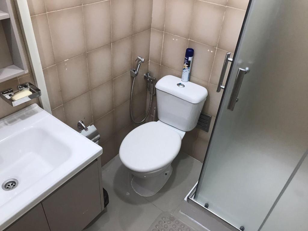 a bathroom with a toilet and a sink and a shower at Casa Kriolu in Praia