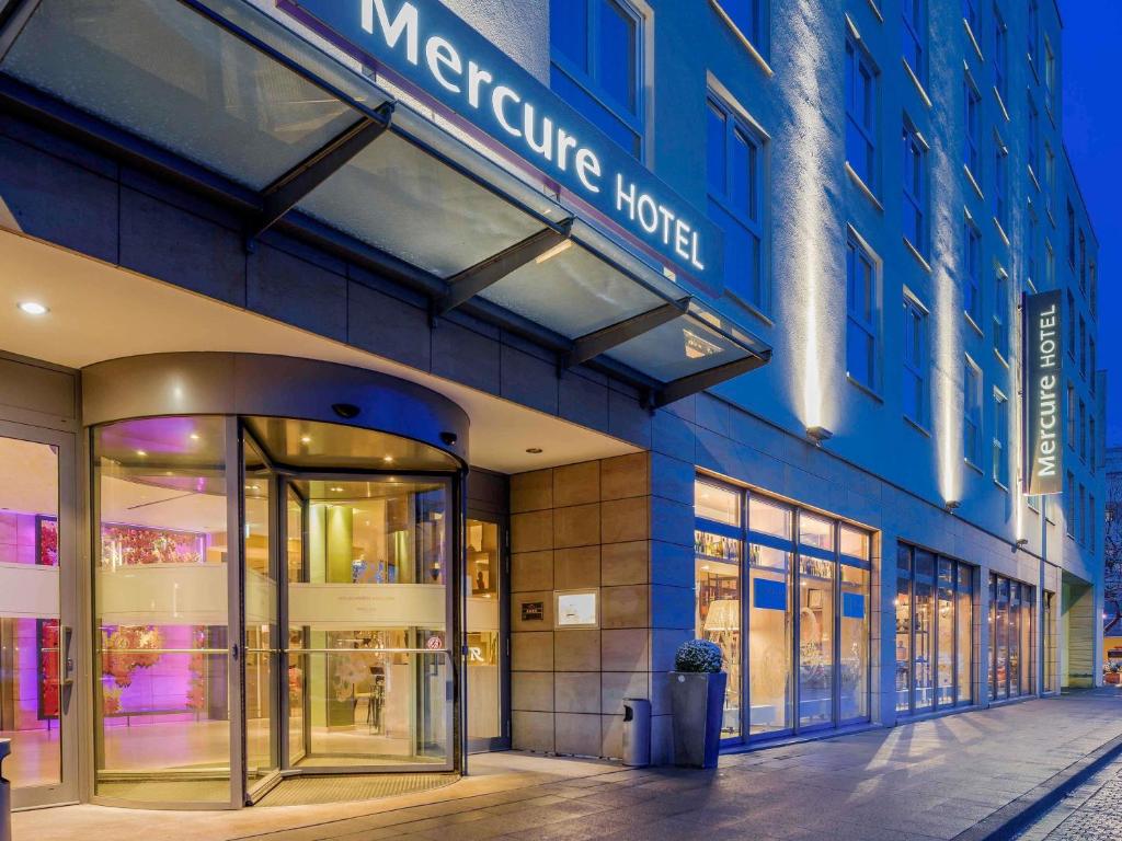 a large blue building with a sign on it at Mercure Hotel Hannover Mitte in Hannover