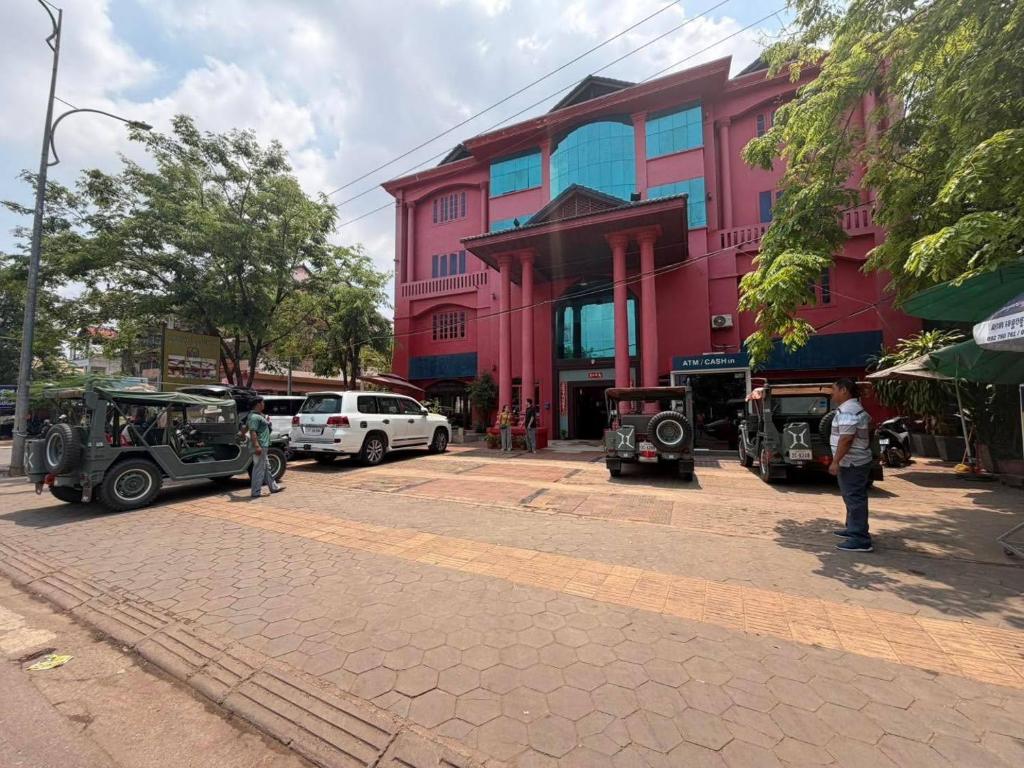 a group of vehicles parked in front of a building at Mongkol Angkor Residence in Phumĭ Trăm Néak