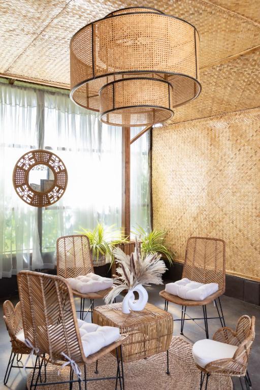 a lobby with chairs and a table and a chandelier at Trisha Guesthouse in San Vicente