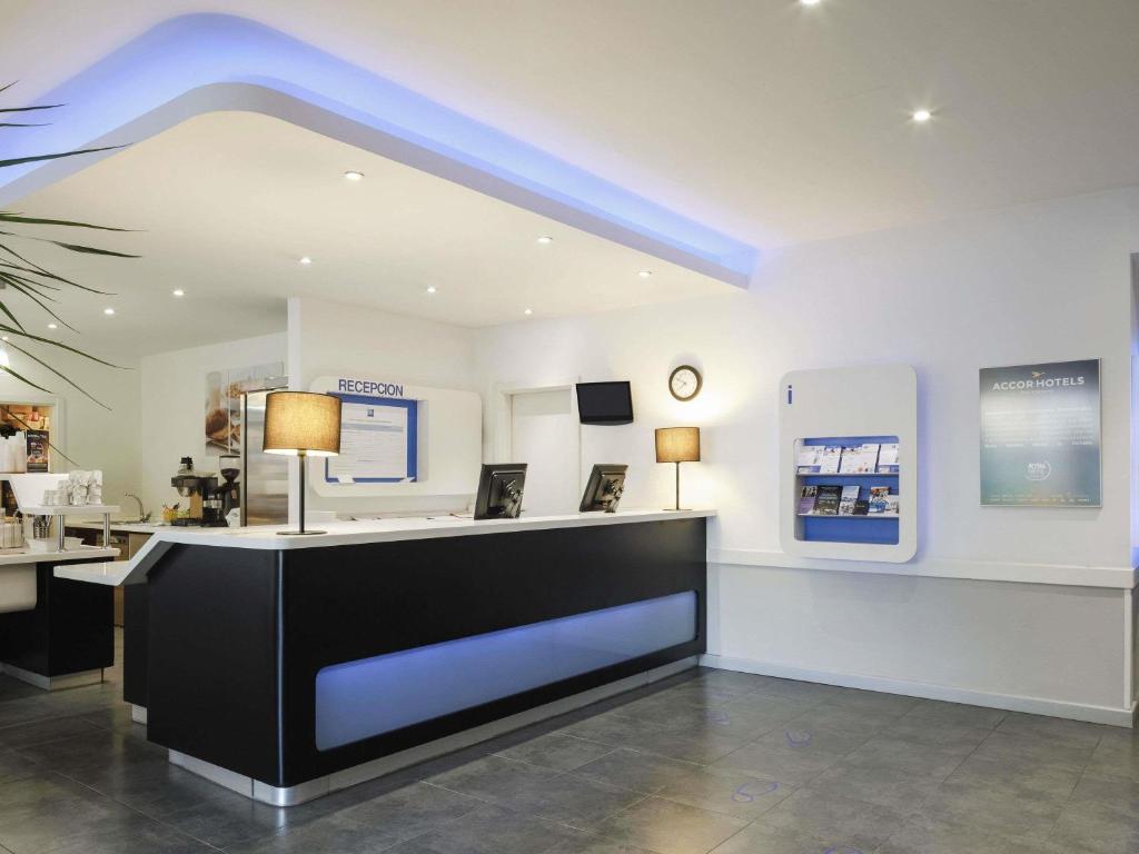 a room with a counter with a blue ceiling at Ibis Budget Málaga Centro in Málaga