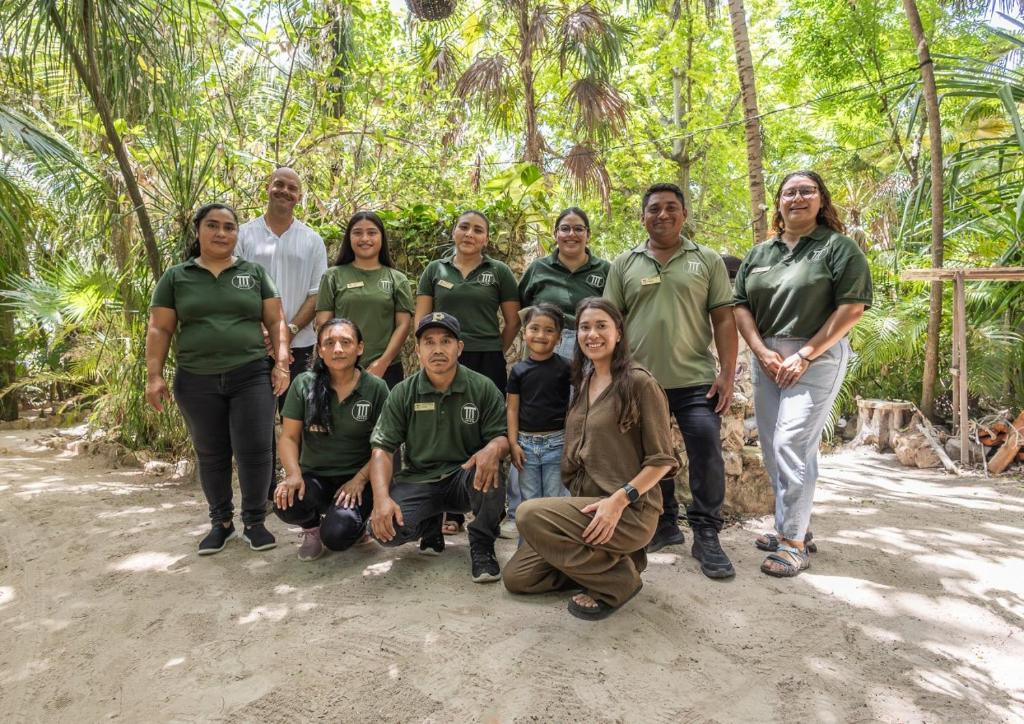 a group of people posing for a picture in the jungle at Amazing 1BR Tulum Jungle with Restaurant, Pool and Gym in Tulum