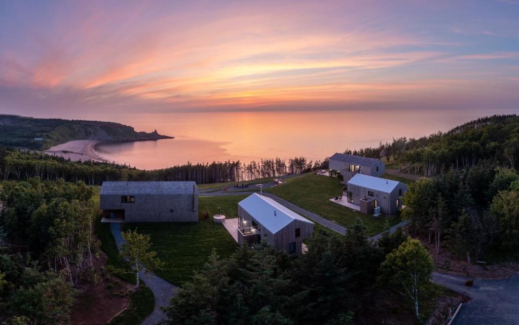 an aerial view of a house on a hill next to a lake at Ridge On The Chimney - 4 Cottages in Chimney Corner