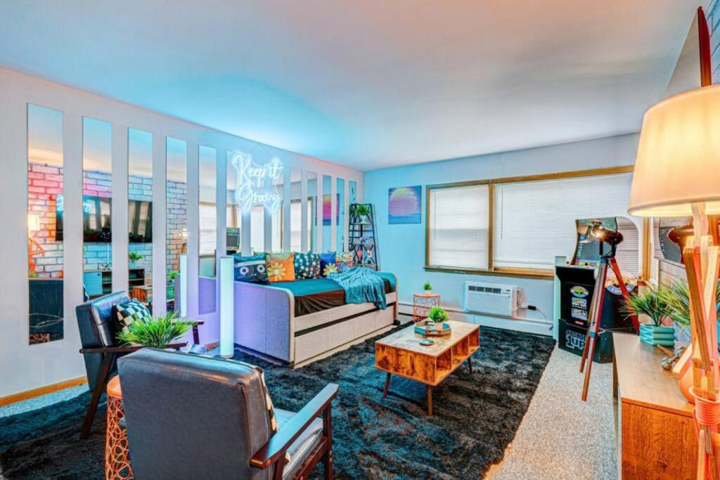 a living room with a couch and a table at 90s Condo| King Bed | 65” Smart TV | Arcade Game in Elmwood Park