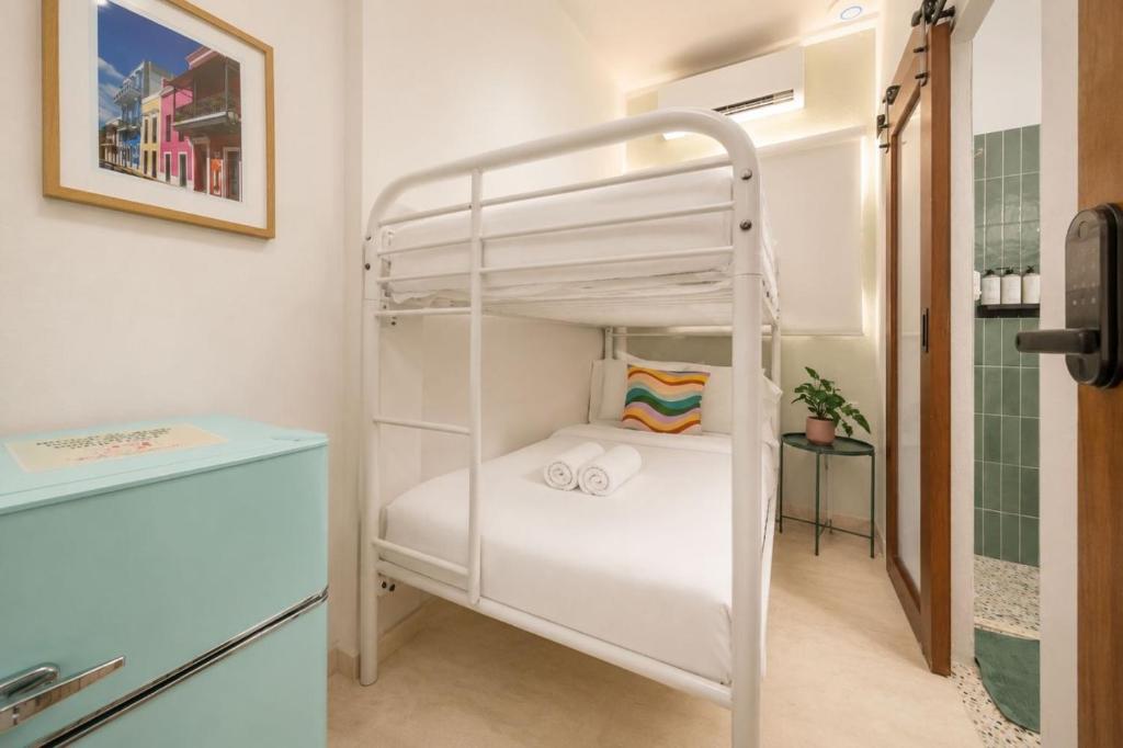 a bedroom with a bunk bed and a bathroom at Room 4: Minimalist Bunk Room w/ Free Parking | San Juan in San Juan