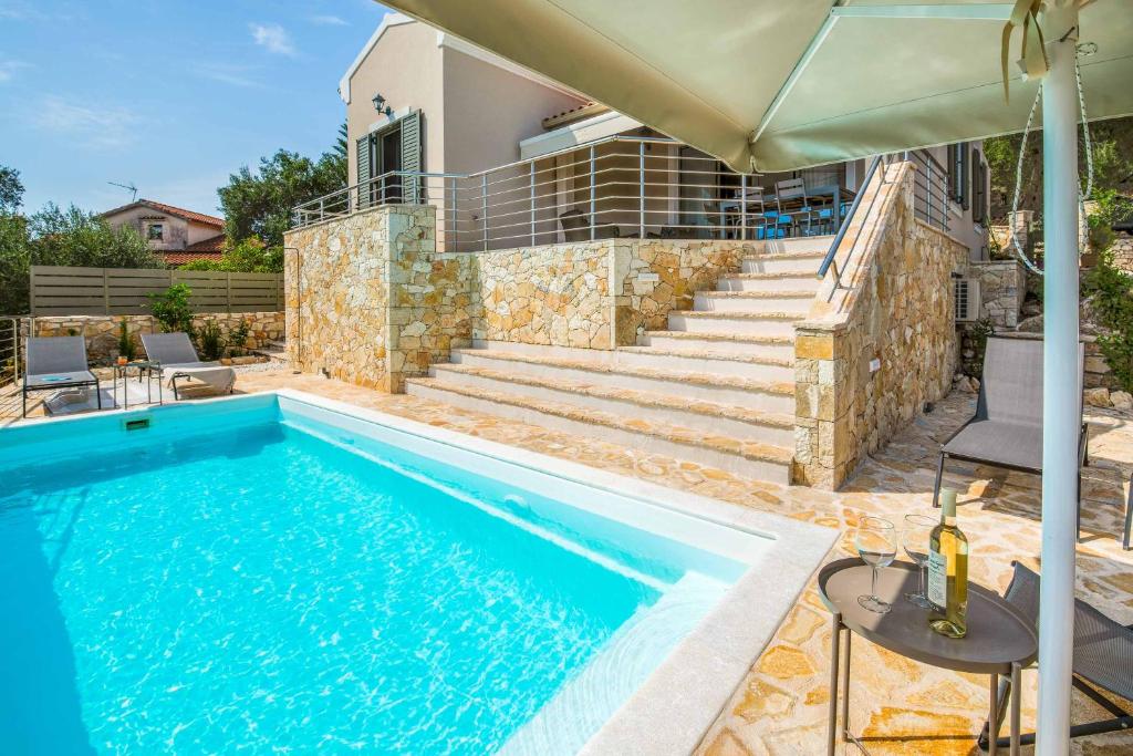 a swimming pool in front of a house at Villa Ares in Bogdanátika