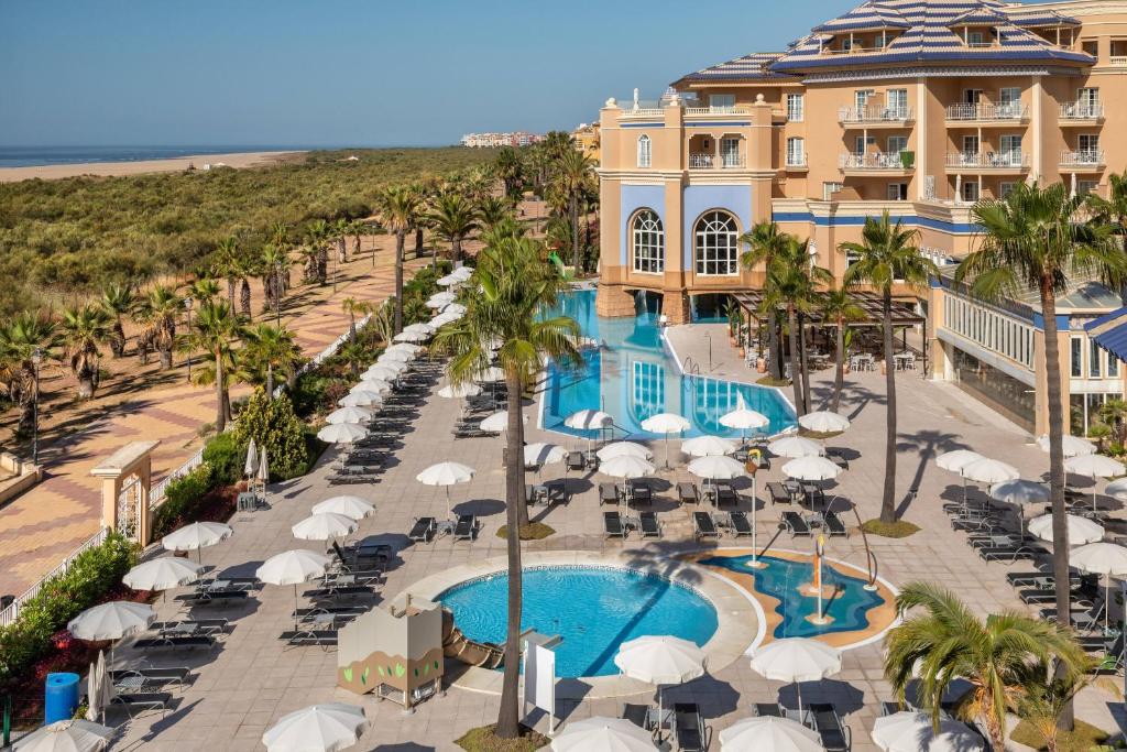 an aerial view of a resort with a pool and beach at Meliá Isla Canela in Isla Canela