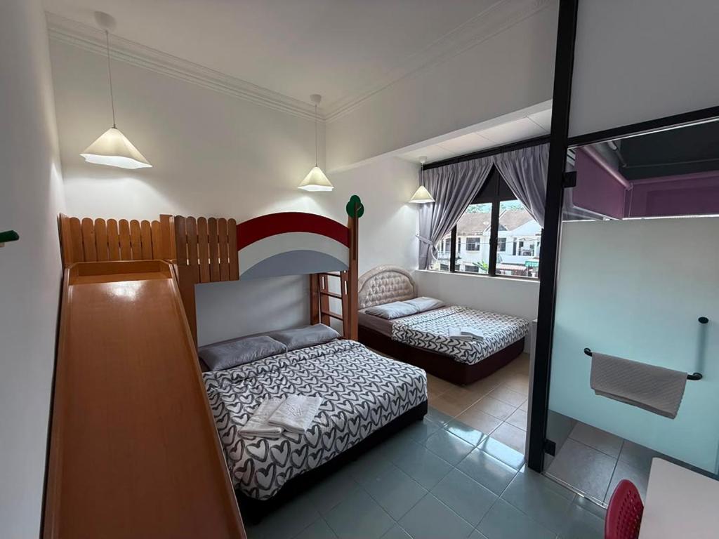 a small bedroom with a bed and a couch at Dino House in Taiping
