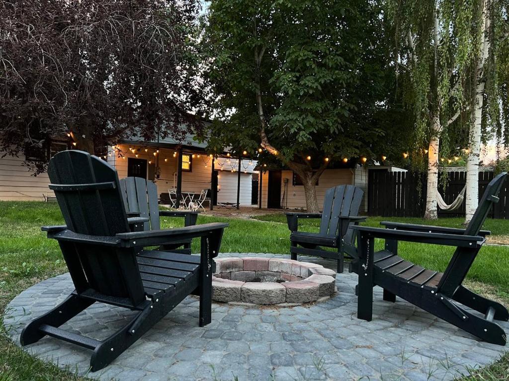 two black chairs sitting next to a fire pit at Private lux lower level flat fully fenced in Twin Falls