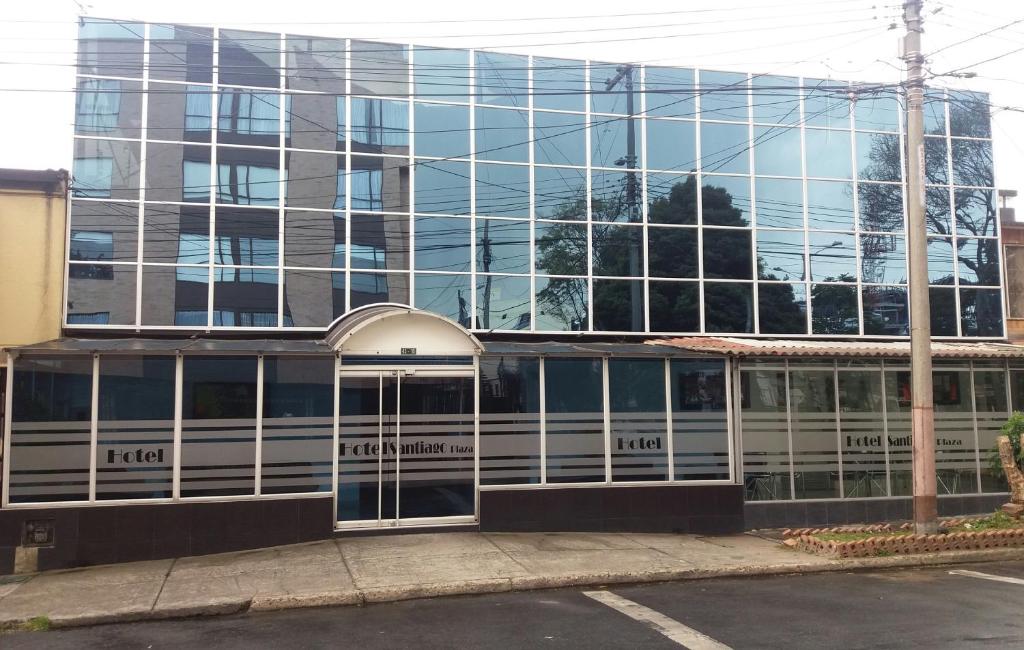 a glass building with a revolving door in front of it at Hotel Santiago Plaza in Bogotá