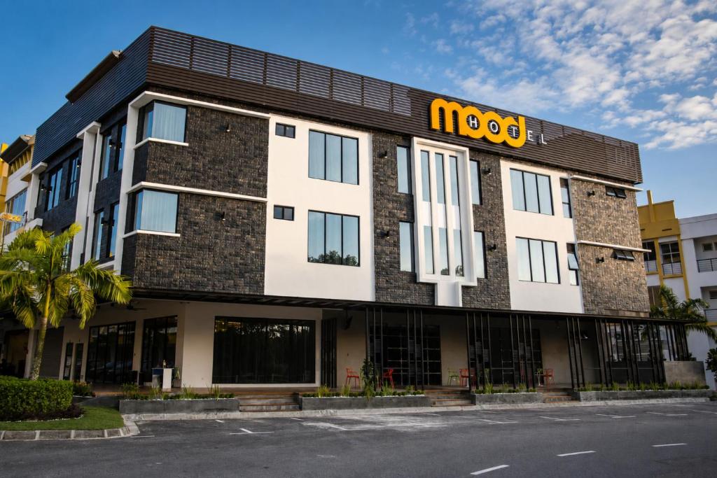a building with a m hotel sign on it at Mood Hotel in Skudai
