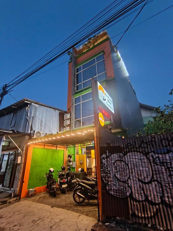 a building with motorcycles parked in front of it at The Cabin Hotel Gandekan in Yogyakarta