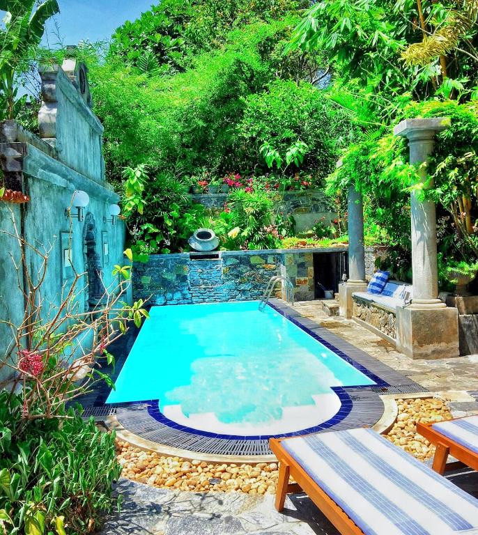 a swimming pool in the middle of a garden at Boutique Villa with a Pool in Kandy